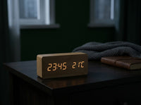 Wooden LED digital alarm clock dimmed to a soft glow in a dark bedroom at night, feature image 3
